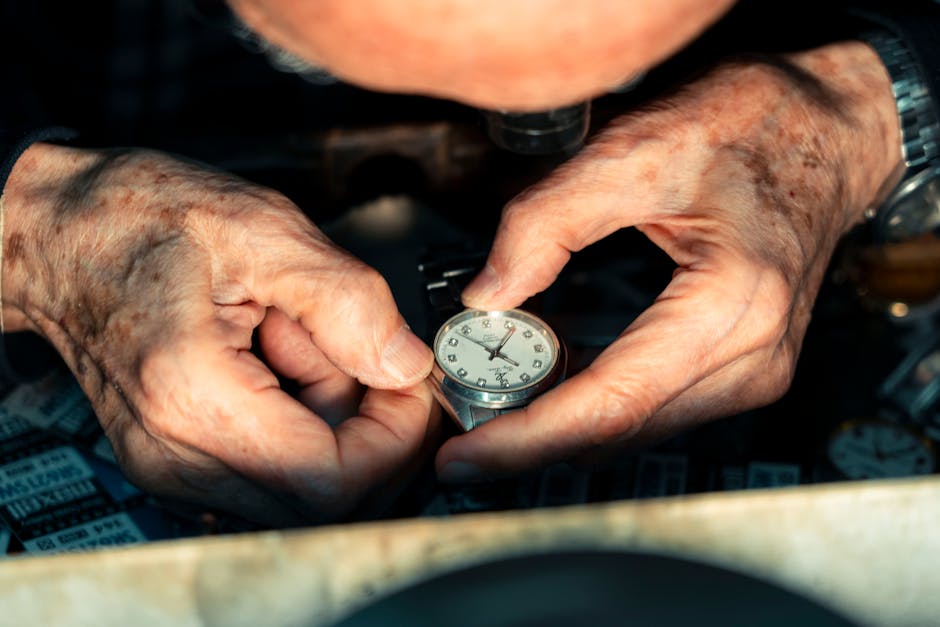 Detailed shot of a watchmaker's hands skillfully repairing a wristwatch under magnification.